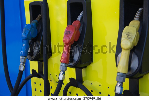 Gas pump nozzles in a\
service station.