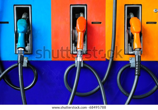 Gas pump nozzles in a\
service station