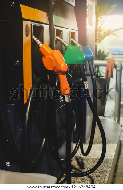 Gas pump nozzles\
in a gas station service.