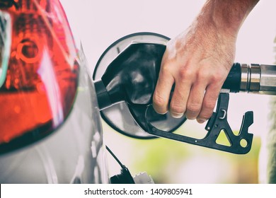 Gas Pump Person Pumping Fuel Filling Car Tank At Gas Station. Man Hand Holding Nozzle Refuel. Price Of Gasoline.