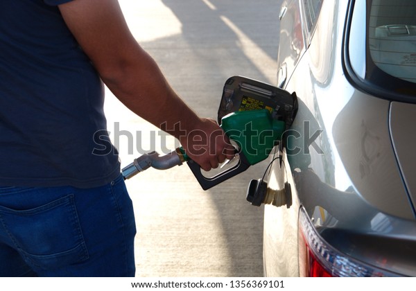 gas\
pump. pumping gas into the car. pump worker\
running
