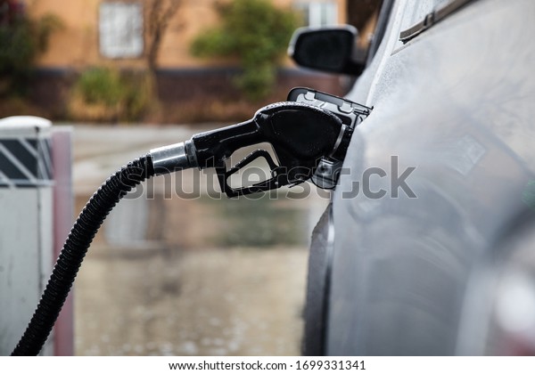 A gas pump\
pumping gas into a truck. gas prices dropping during the global\
pandemic caused by COVID-19. people are not traveling by car much\
to work or by plane. recession upon\
us