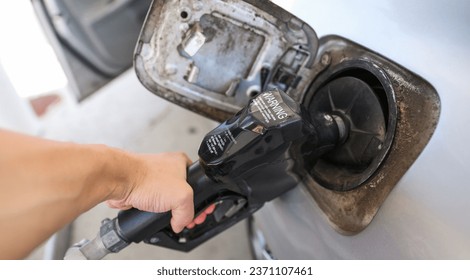 gas pump stands outside a hospital, representing rising fuel costs impacting healthcare budgets, essential services, and patient access - Powered by Shutterstock