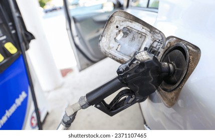 gas pump stands outside a hospital, representing rising fuel costs impacting healthcare budgets, essential services, and patient access - Powered by Shutterstock