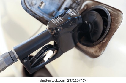 gas pump stands outside a hospital, representing rising fuel costs impacting healthcare budgets, essential services, and patient access - Powered by Shutterstock