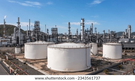 Oil​ and Gas refinery petrochemical​ plant industrial with oil and gas storage tank, White oil and gas refinery storage tank, Aerial view Oil and gas refinery plant from industry zone.