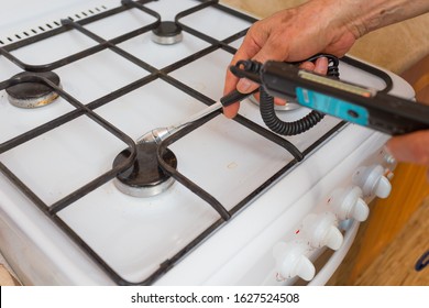 A Gas Safety Specialist Checks A Gas Stove In An Apartment Of A Residential Building For Leaks Of Household Gas Using A Measuring Device A Propane Analyzer