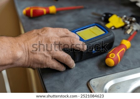 Gas service engineer technician operating boiler flue gas analyzer during annual maintenance of domestic boiler