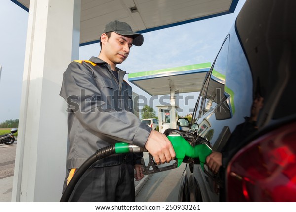 Gas station attendant at\
work