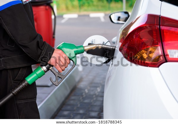 Gas station attendant at work. Car refueling on a\
petrol station