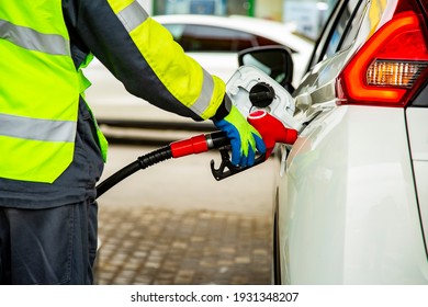 Gas Station Employee In Overalls Refueling The Car With Petrol Close Up. No Face