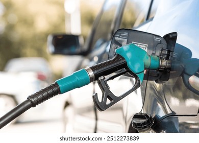 The gas station. Filling the car with gasoline. A Russian fuel dispenser in the fuel tank of a car at a gas station. Rising fuel prices around the world. - Powered by Shutterstock