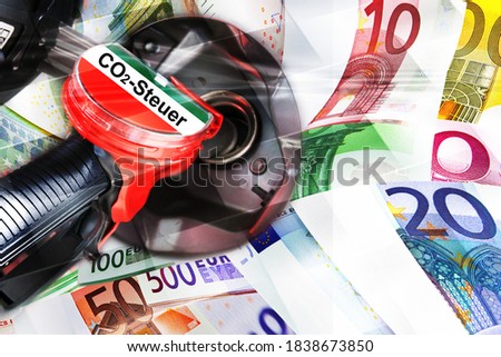 Gas station fuel nozzle with inscription Co2 tax and euro banknotes