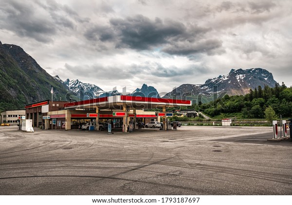 gas station and\
mountains under cloudy sky
