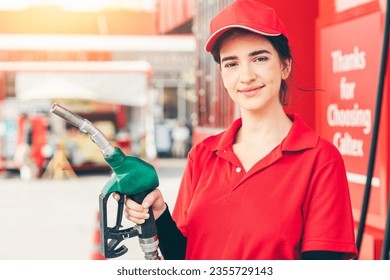 Gas station service staff worker women happy smiling with fuel nozzle for car gasoline refill job - Powered by Shutterstock