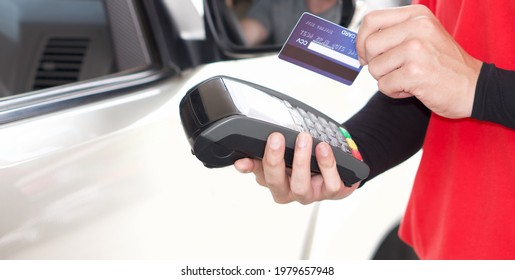 Gas Station Worker Swipe Mockup Credit Card Via Payment Terminal After Giving A Price Quote To The Customer Sitting In The Car.