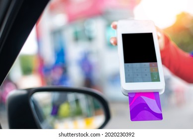 Gas Station Worker Swipe Mockup Credit Card Via Payment Terminal After Giving A Price Quote To The Customer Sitting In The Car.