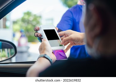 Gas Station Worker Swipe Mockup Credit Card Via Payment Terminal After Giving A Price Quote To The Customer Sitting In The Car.