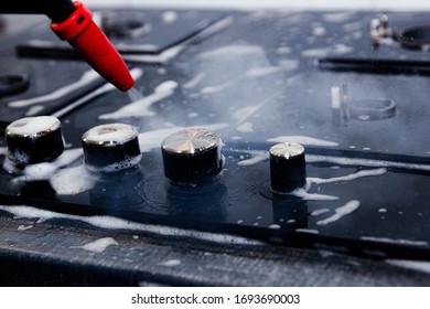 gas stove cleaning with a steam cleaner in the kitchen. disinfection when cleaning the house. - Shutterstock ID 1693690003