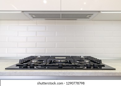 Gas Stove And Exhaust Hood In The Kitchen.