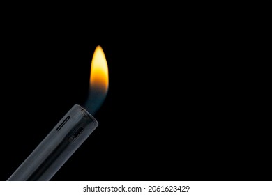 Gas Stove Lighter Ignition On Black Background. Fire And Fire Safety. Gas Leak Hazard Concept. Close-up