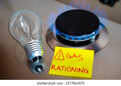 Gas stove, with yellow note next to it with text "gas rationing" and light bulb off. Rationing and insufficiency in gas flows. Energy crisis.
 - Shutterstock ID 2177814373