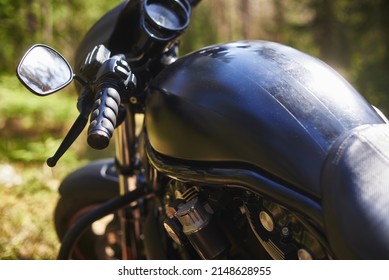 Gas Tank And Handlebars With A Mirror Of A Modern Black Motorcycle. Defocused Front Suspension With Wheel And Shock Absorber.