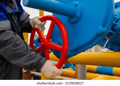 Gas transmission system and gas pipeline. Communications, the worker opens and closes the valve at the gas pumping station.  - Shutterstock ID 2170928317