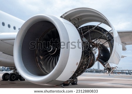 Gas turbine engine close up during maintenance when airplane park at the airport.Mechanic and technician repair hydraulic and check system of power plant.