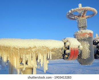 Gas valve and high pressure pipe. Oil and gas industry. Frozen icicles