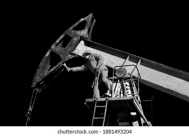 Gas Worker Engineer Oil Worker Checks The Operation Of The Pipeline And Pump At The Beginning Of Winter. Classic Black And White Reportage Photo.