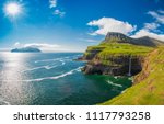 Gasadalur village and Beautiful  waterfall, Sunny Day, Vagar, Faroe Islands, Denmark. 

