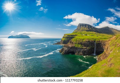 Gasadalur Village And Beautiful  Waterfall, Sunny Day, Vagar, Faroe Islands, Denmark. 

