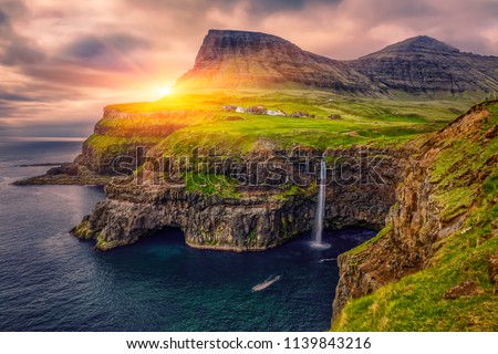 Gasadalur village and Beautiful  waterfall, At Sunset, Vagar, Faroe Islands, Denmark.