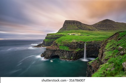 Gasadalur Village And Its Iconic Waterfall, Vagar, Faroe Islands, Denmark. Long Exposure.