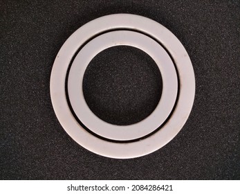 

Gasket Or Packing Product Is White With A Circle Made Of Teflon On A Black Background

