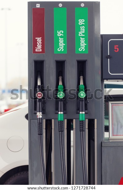 gasoline and diesel distributor at the gas\
station, gas pump\
nozzles