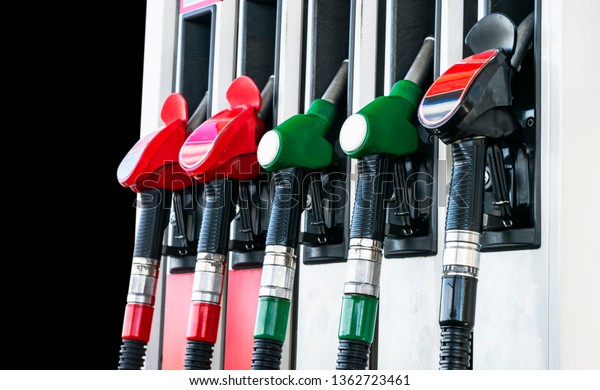Gasoline and diesel\
distributor at the gas station. Gas pump nozzles. Petrol filling\
gun close-up at the gas station. Colorful Petrol pump filling\
nozzles. Fuel pump