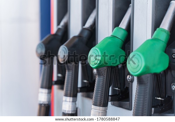 Gasoline\
and diesel distributor at the gas station. Gas pump nozzles. Petrol\
filling gun close-up at the gazoline\
station.