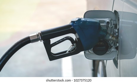 A Gasoline Dispenser Filling To A Van In Gas Station After Loan Road Trip.