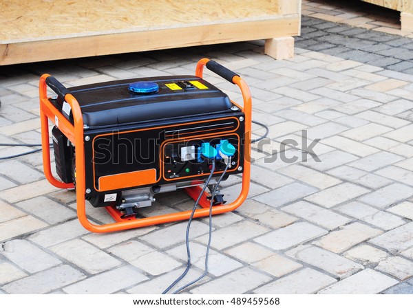  Gasoline Portable Generator on the  House\
Construction Site. Close up on Mobile Backup Generator .Standby\
Generator - Outdoor Power\
Equipment