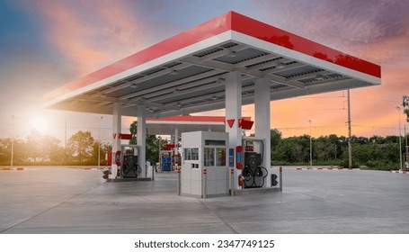 Gasoline pump nozzle sign. Fuel pump petrol station,Oil and Gas station at sunrise and orange sky . - Powered by Shutterstock