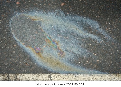 Gasoline Spill On Asphalt In A Car Park As A Texture Or Background.