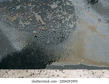 Gasoline Spill On Asphalt In A Car Park As A Texture Or Background.