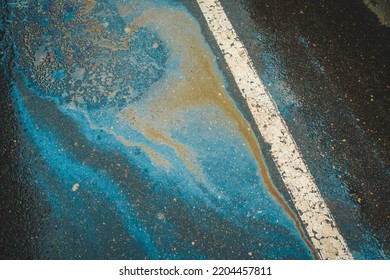 Gasoline Spill On Asphalt In A Car Park As A Texture Or Background.