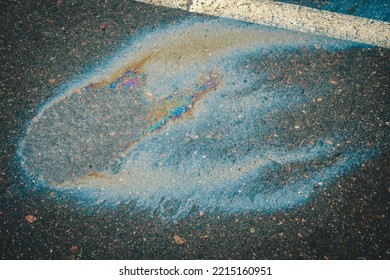 Gasoline Spill On Asphalt In A Car Park As A Texture Or Background.