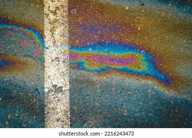 Gasoline Spill On Asphalt In A Car Park As A Texture Or Background.