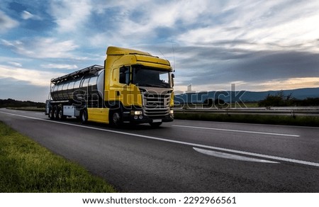 Gasoline tanker, Oil trailer, Tank truck on highway close up on a Highway road with a beautiful dramatic sunset sky in the background