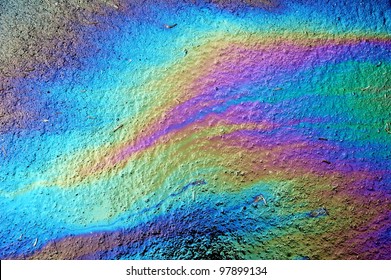 Gasoline that had leaked onto a wet parking lot creates a rainbow oil slick