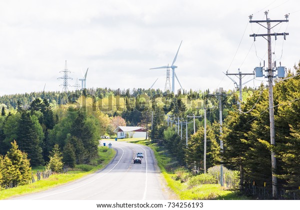 Gaspesie coast road trip in Quebec, Canada with\
wind turbines in\
Capucins